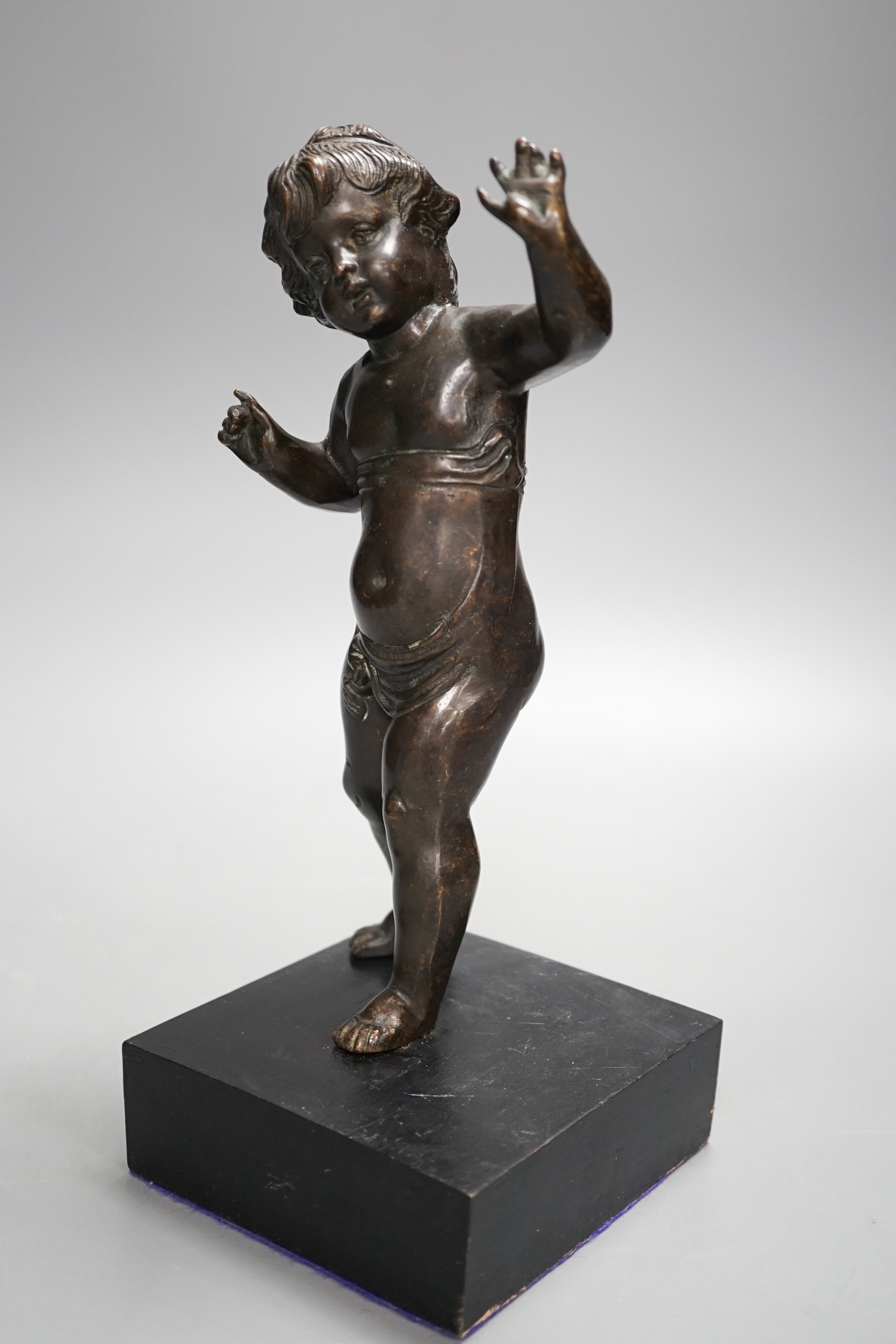 A 20th century bronze putto on wooden stand 29cm including stand